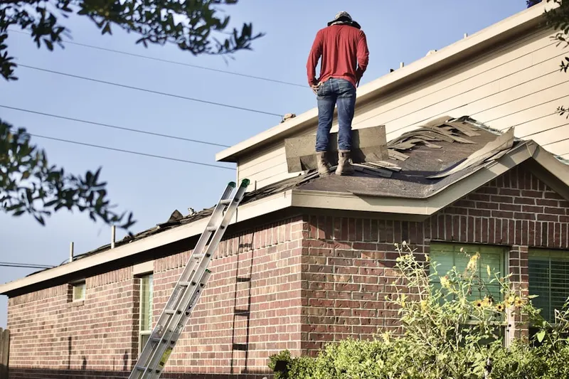 Professional roofer working on a residential roof in Crownridge Estates